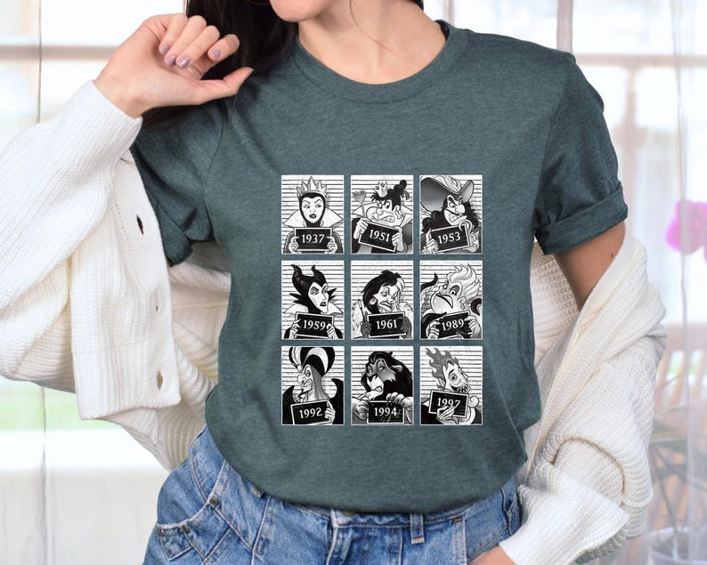 Puede incluir: Camiseta verde oscuro con un gr&aacute;fico en blanco y negro de nueve villanos de dibujos animados en cajas estilo ficha policial, cada uno con un a&ntilde;o. La camiseta es de cuello redondo y tiene mangas cortas. El gr&aacute;fico incluye personajes de varias pel&iacute;culas de animaci&oacute;n.