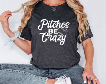 May include: Dark gray t-shirt with the white text "Pitches BE Crazy" and a baseball graphic. The shirt is a crew neck and appears to be made of a soft material.