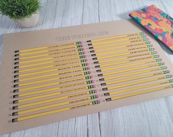 May include: A brown cardboard board with 30 yellow pencils arranged vertically. Each pencil has a different inspirational quote printed on it. The board is labelled "The Pencil Jig".