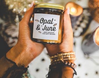 May include: A brown glass candle jar with a gold lid. The label on the jar reads "Opal & June" with the text "Happy Mockups for Happy Designs".