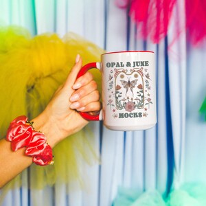15 Oz Mug Mockup of White Mug with Red Handle and Interior: Colorful Photo of Model Holding 15 Oz Mug with Red Handle, Mockup with Bows