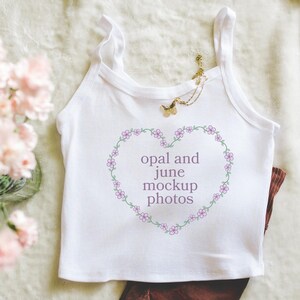 Folded White Tank Top Mockup: Colorful Photo of Folded White Bella Canvas 1012Tank Top, Simple Minimalist Lifestyle Mockup with Flowers