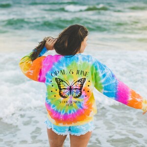 Back of Sweatshirt Mockup: Photo of Model Wearing Eternity Colortone® 8100 Sweatshirt at Beach | Colorful Lifestyle Mockup of Tie Dye Shirt