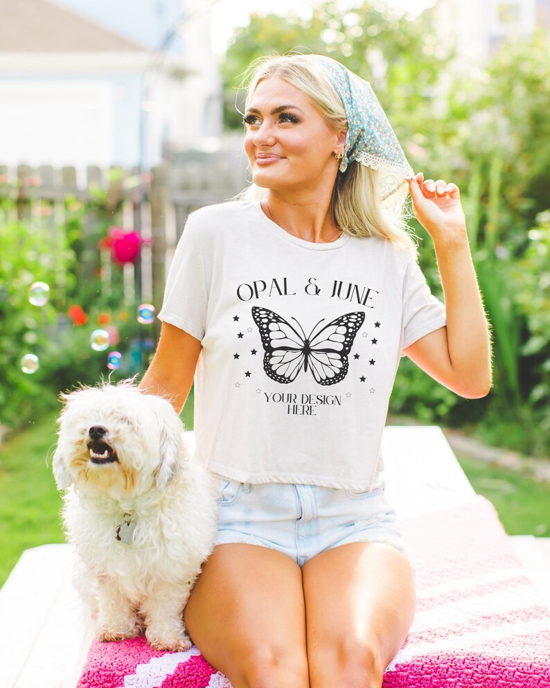 May include: A white t-shirt with a black butterfly graphic and the text "OPAL & JUNE" and "YOUR DESIGN HERE".