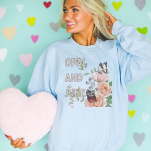Light Blue Sweatshirt Mockup: Colorful Photo of Model Wearing Light Blue Gildan 18000 Crewneck, Fun and Creative Spring Mockup with Hearts