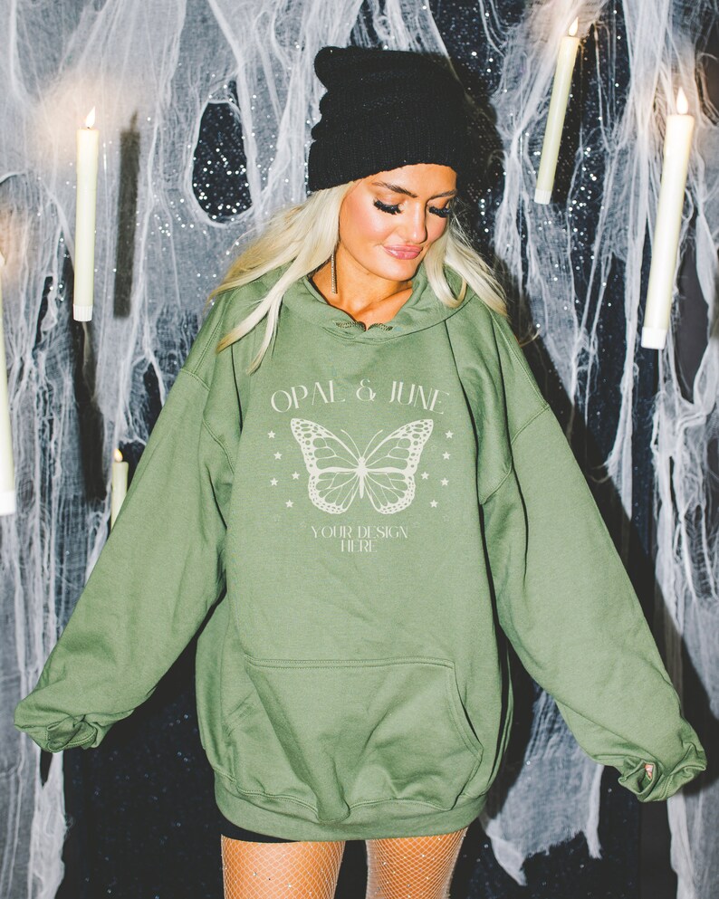 May include: A green hooded sweatshirt with a white butterfly graphic and the text "OPAL & JUNE" and "YOUR DESIGN HERE".