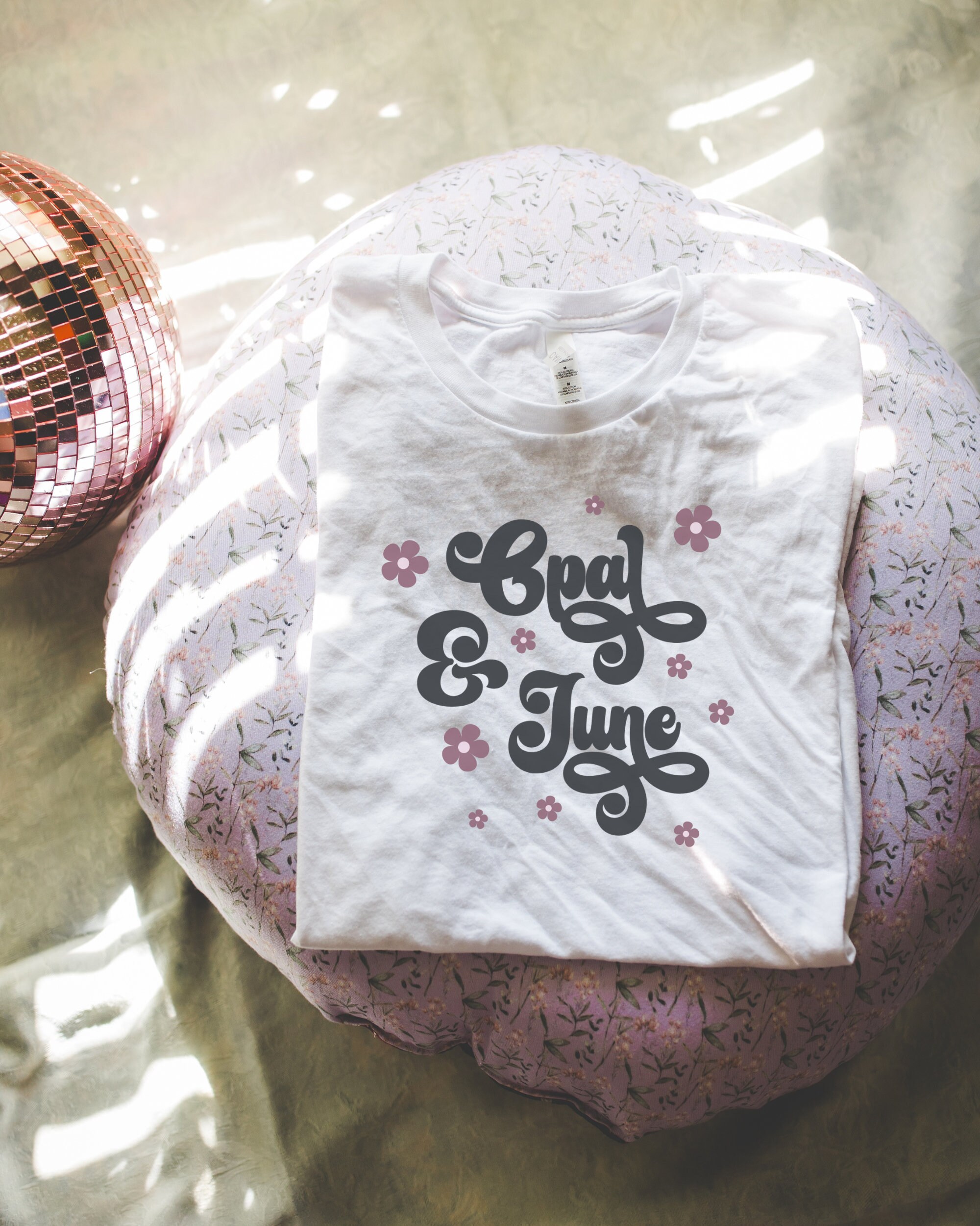 White Shirt Mockup: Colorful Photo of Folded White Bella Canvas 3001 Tee Shirt, Trendy Lifestyle Mockup Photo with Cute Floral Disco Vibe