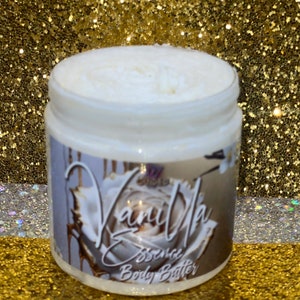 May include: A white jar of Vanilla Essence Body Butter with a white rose and gold accents on the label.