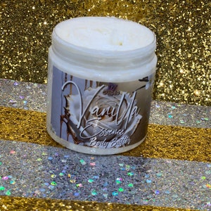 May include: A white jar of vanilla scented body butter with a gold and white label that says "Vanilla Essence Body Butter".