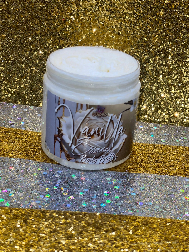 May include: A white jar of vanilla scented body butter with a gold and white label that says "Vanilla Essence Body Butter".