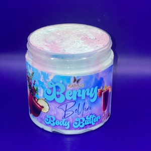 May include: A white jar of body butter with a pink and blue swirl on top. The label says "Guided Berry Bellini Body Butter".