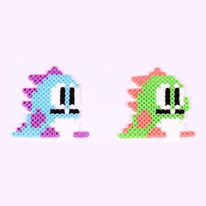 May include: Two pixel art style characters made of colorful beads. The character on the left is blue, white, and purple. The character on the right is green, white, and orange.