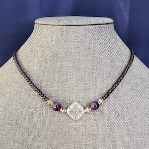 Dark Amethyst Necklace - A dainty beaded purple glass design, featuring a vintage pendant center, with purple glass and silver accents.