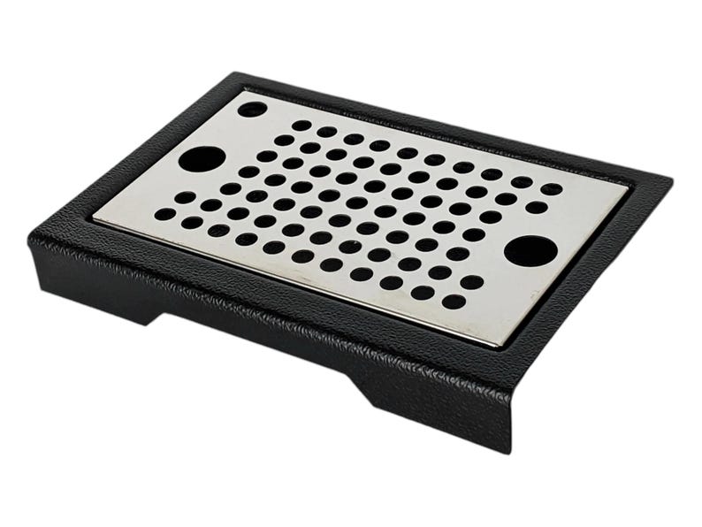 May include: Black rectangular drip tray with a stainless steel perforated insert. The tray has a textured surface and rounded edges.