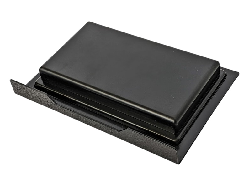May include: Black plastic storage box with a hinged lid. The lid has a raised edge around the perimeter.
