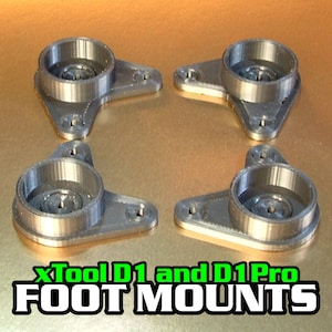 以下が含まれることがあります： xTool D1とD1 Proレーザー彫刻機用の、銀色の3Dプリントされたフットマウントが4つ。マウントの中央には円形の開口部があり、3つの取り付け穴があります。