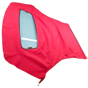 May include: Red convertible car roof with a rear window. The roof is made of fabric and has a zipped seam.
