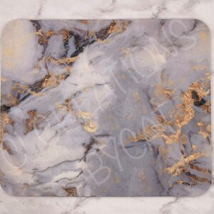 May include: A gray and white marble-patterned mousepad with gold accents.