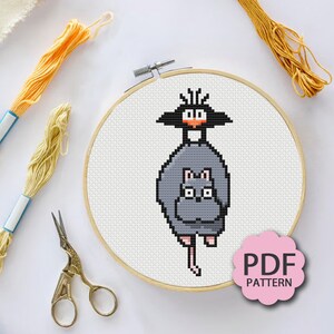 May include: Cross stitch pattern featuring a gray cat with a black cat on its back. The pattern is in a wooden embroidery hoop and includes the text "PDF PATTERN".