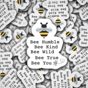 May include: A white background with a bee illustration and the text "Bee Humble, Bee Kind, Bee Wild, Bee True, Bee You". The background is covered with smaller white circles with bee illustrations and the same text repeated in various combinations.