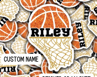 May include: A sticker or magnet featuring a basketball with a gold net and the name "RILEY" in black letters. The basketball is orange with glitter and the net is gold with glitter. The background is white with a custom name field.