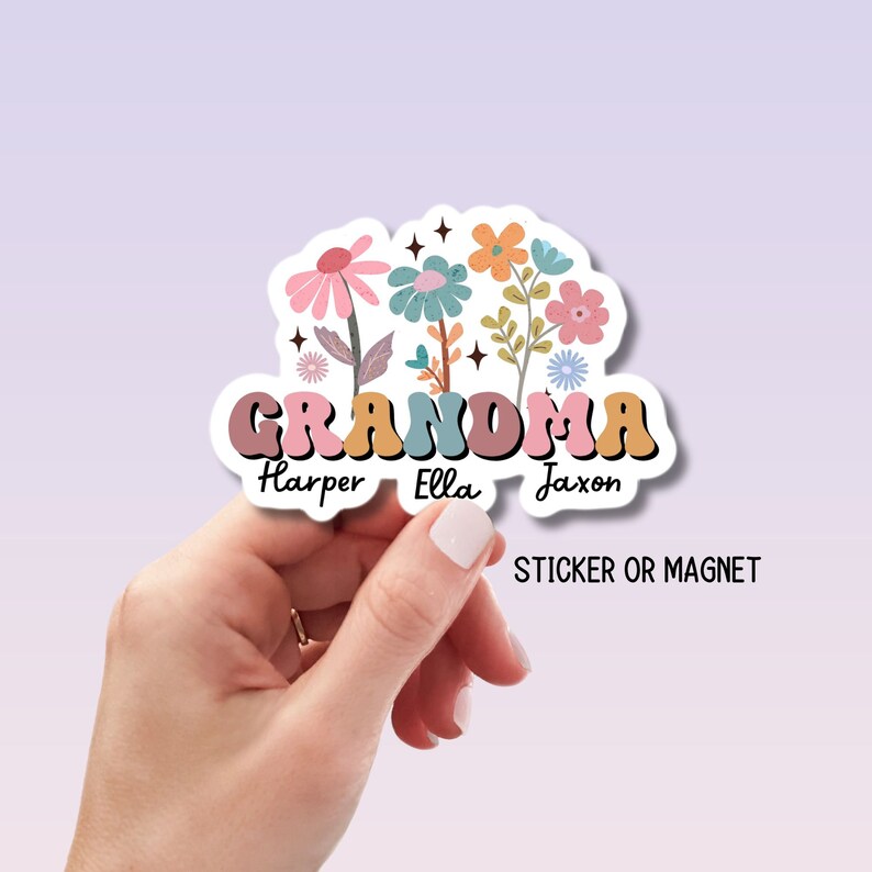 May include: A colorful sticker or magnet with the word "Grandma" in a retro font, surrounded by flowers and the names "Harper", "Ella", and "Jaxon".