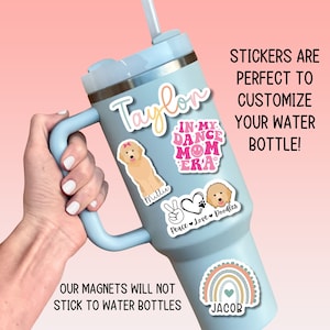 a person holding a cup with stickers on it
