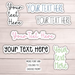 May include: A collection of stickers with the text "Your Text Here" in various fonts and colors. The stickers are in white with different colored text, including blue, black, pink, and green. The text "MORE FONT AND COLORS TO CHOOSE FROMT" is also visible.