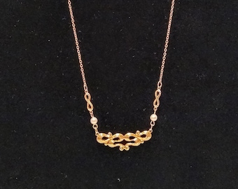 Vintage Avon gold tone necklace with faux pearl bead accents.