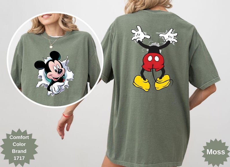 Peut inclure: T-shirt vert mousse avec Mickey Mouse. Le motif avant montre Mickey per&ccedil;ant un effet d&eacute;chir&eacute;, tandis que le dos affiche les bras et les jambes de Mickey. Le t-shirt est de la marque Comfort Color.