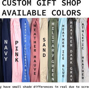 May include: Image displays a color chart for a custom gift shop, showcasing available colors. Colors include white, heather maroon, black, navy, pink, Columbia blue, heather mauve, sand, military green, ice blue, heather dark gray, athletic heather, red, and kelly green.