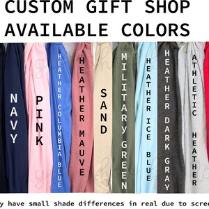 May include: Image displays a color chart for a custom gift shop, showcasing available colors. Colors include white, heather maroon, black, navy, pink, Columbia blue, heather mauve, sand, military green, ice blue, heather dark gray, athletic heather, red, and kelly green.