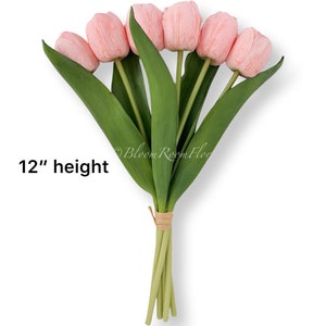 May include: A bouquet of 6 pink artificial tulips with green stems and leaves. The bouquet is tied together with twine and measures 12 inches in height.  "12" height"