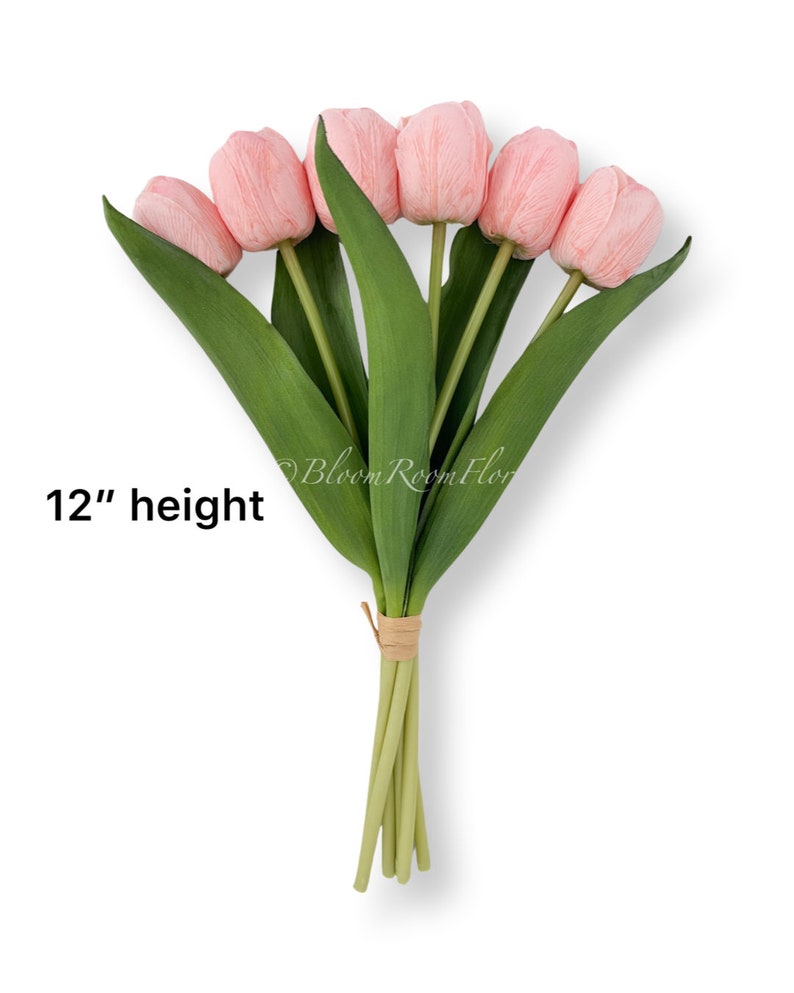 May include: A bouquet of 6 pink artificial tulips with green stems and leaves. The bouquet is tied together with twine and measures 12 inches in height.  "12" height"