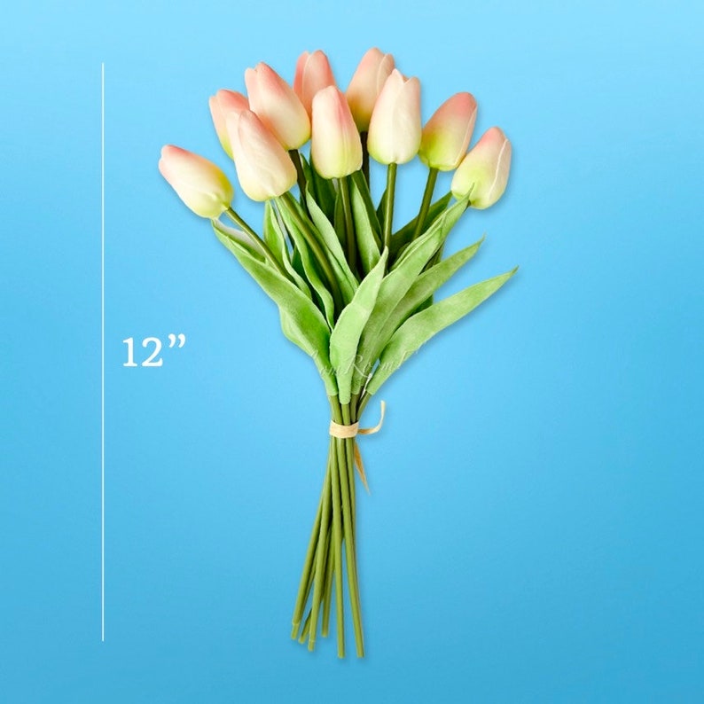May include: A bouquet of 12 pink artificial tulips with green stems, tied together with twine. The bouquet is 30.5 cm tall.