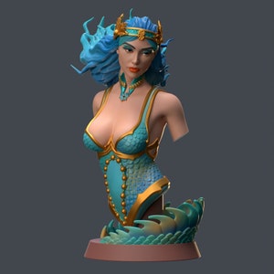 May include: A bust of a mermaid with flowing blue hair and a golden crown. The mermaid wears a teal and gold scaled bodice with a matching necklace. The base is a stylized tail, and the overall design is a fantasy art piece.