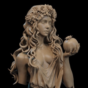 May include: A detailed bust sculpture of a woman with long, flowing hair and a floral crown. She is holding a pomegranate in her right hand. The sculpture is a light beige color and set against a black background.