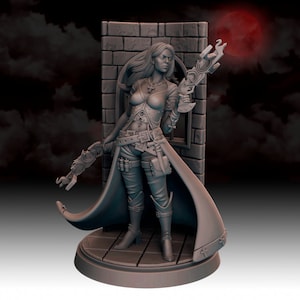 May include: A grey painted miniature figurine of a woman wearing a long coat and holding a steampunk-style weapon. She is standing on a circular base with a brick wall behind her.