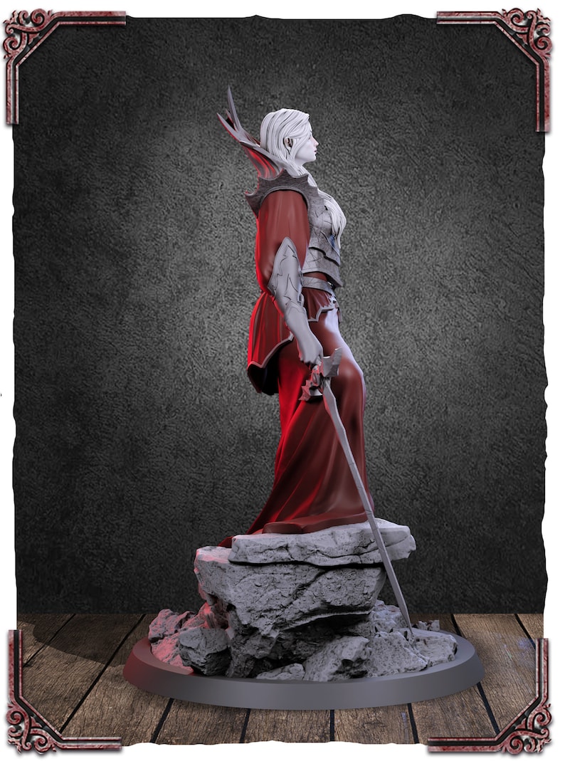 May include: A white female figurine with long white hair and a red robe, holding a sword. The figurine is standing on a rocky base.