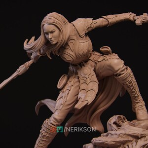 May include: A detailed sculpture of a female warrior in a dynamic pose, clad in ornate armor and holding a sword. The figure has long hair and is sculpted in a neutral, earthy tone. The sculpture is set against a dark background.