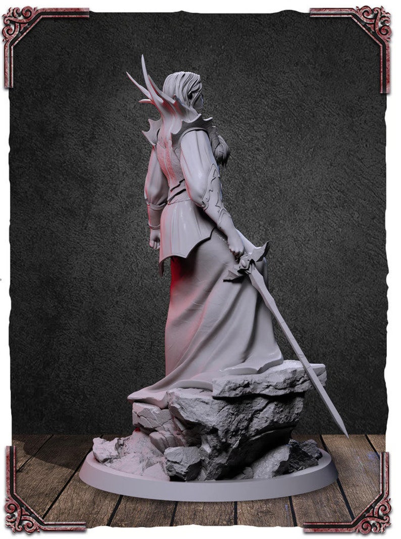 May include: A white painted figurine of a person wearing a flowing robe and holding a sword. The figurine is standing on a rocky base.