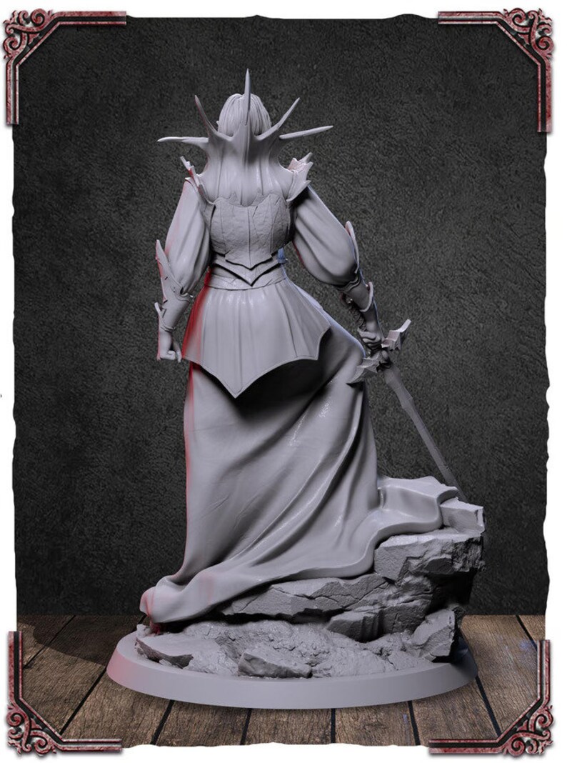 May include: A gray, detailed, 3D printed figurine of a female figure wearing a flowing gown and armor, holding a sword. The figure is standing on a rocky base.