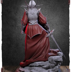 May include: A detailed figurine of a female figure in a red gown and armor, standing on a rocky base. The figure has a spiky crown and holds a sword.