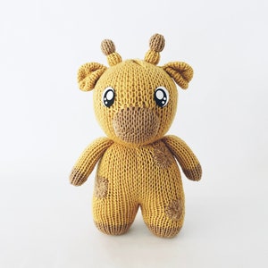 May include: Knitting machine pattern PDF for a yellow and brown giraffe plush toy. The giraffe has large eyes and a brown nose.