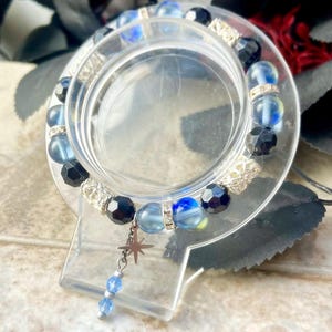 Celestial Glow Armband - Blue Aura Kristall, schwarze Facettierung, Metallröhrchen, Edelstahl Stern Anhänger