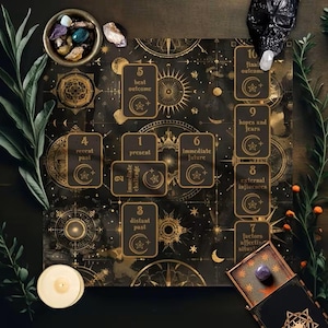 May include: A black and gold tarot reading mat featuring celestial motifs and ten numbered card placement positions labeled with text including present, recent past, distant past, best outcome, immediate future, and final outcome.