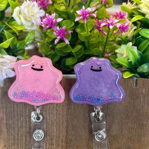 Anime inspired ditto resin shaker badge reel , alligator clip
