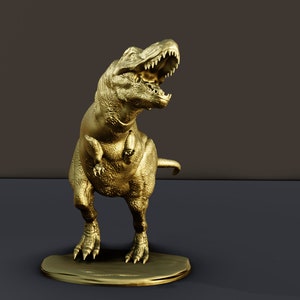 Puede incluir: Una figurita de dinosaurio Tyrannosaurus Rex dorada con la boca abierta, de pie sobre una pequeña base.