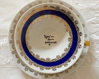 Teetasse "you've been poisoned" gold & blau