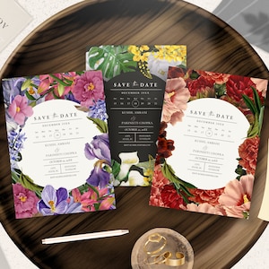 May include: Three save the date cards with floral designs. The cards are white with black text and feature a calendar with the date 17 December 2023. The text on the cards reads "Save the Date" and includes the names "Kushi Ambani" and "Parineeti Chopra".